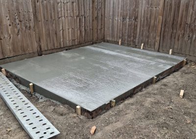 Grey porcelain raised patio project with sleeper surrounds in Chelmsford